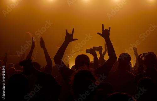 Man raising up hands at rock concert