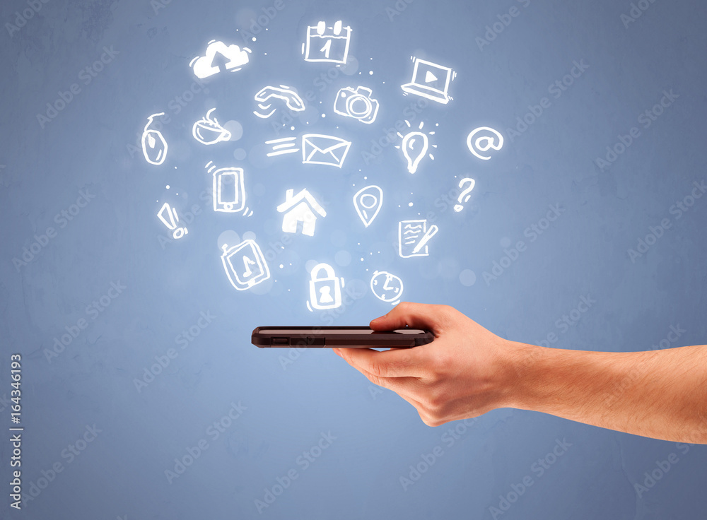 Hand holding tablet phone with drawn icons Hand holding tablet phone with drawn icons
