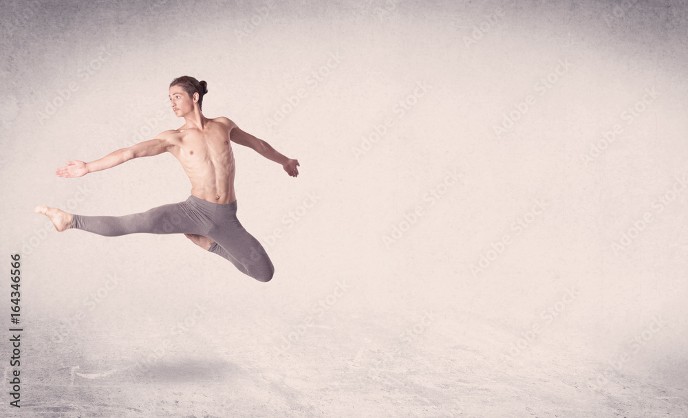 Naklejka premium Modern ballet dancer performing art jump with empty background