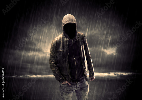 Anonymous terrorist in hoodie at night