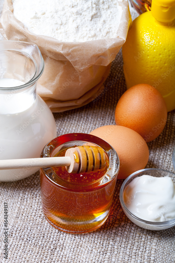 Ingredients for honey pastry on old dark wooden table and linen napkin. Selective focus. Shallow depth of field Ingredients for honey pastry on old dark wooden table and linen napkin. Selective focus. Shallow depth of field