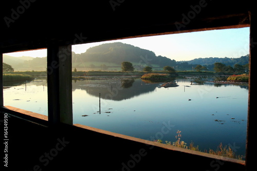 Sunrise over Black Hole Marsh in Seaton Wetlands, Devon seen from bird hide, Devon