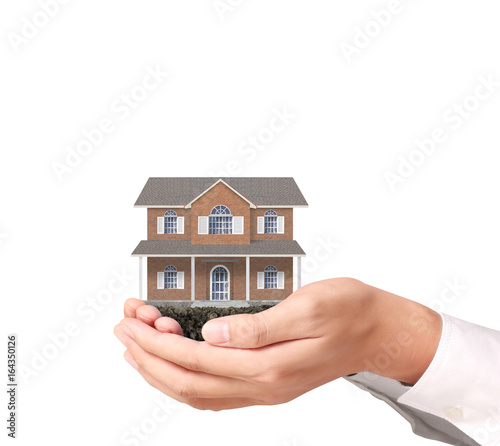 Mortgage concept by house in hand