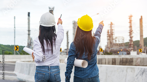 Asian women worker and engineer electrician work safety control at power plant energy industry , Thailand. Engineer Concept,worker,industrial