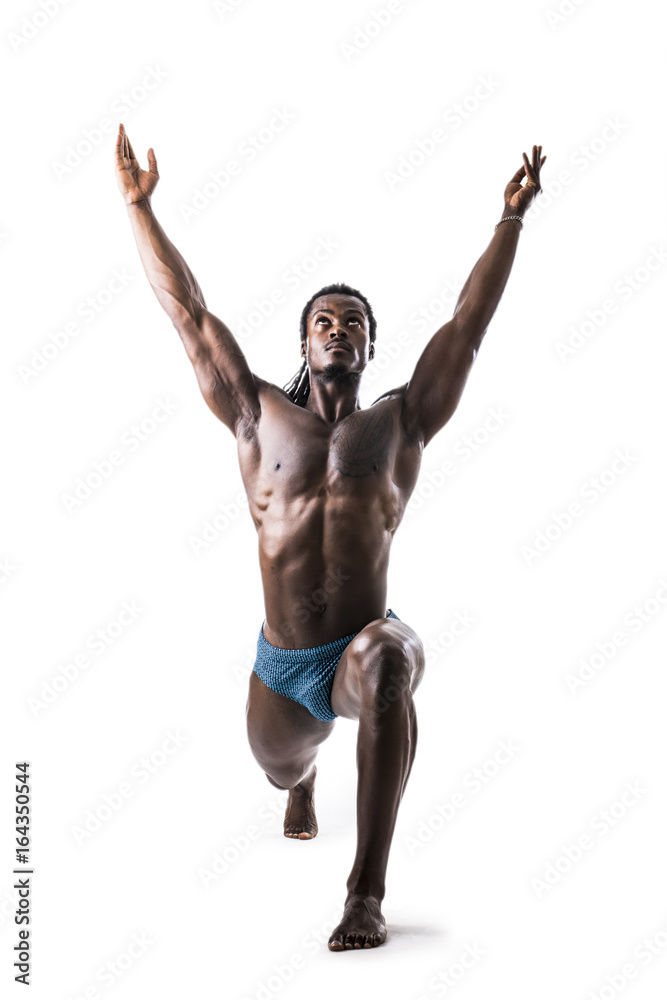 Black muscular handsome young man doing yoga exercises in studio, isolated on white background. Full body photo Black muscular handsome young man doing yoga exercises in studio, isolated on white background. Full body photo