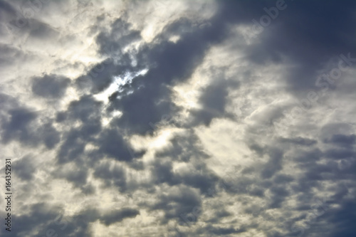 Fototapeta Naklejka Na Ścianę i Meble -  Gray sky with clouds with translucent rays of the sun.