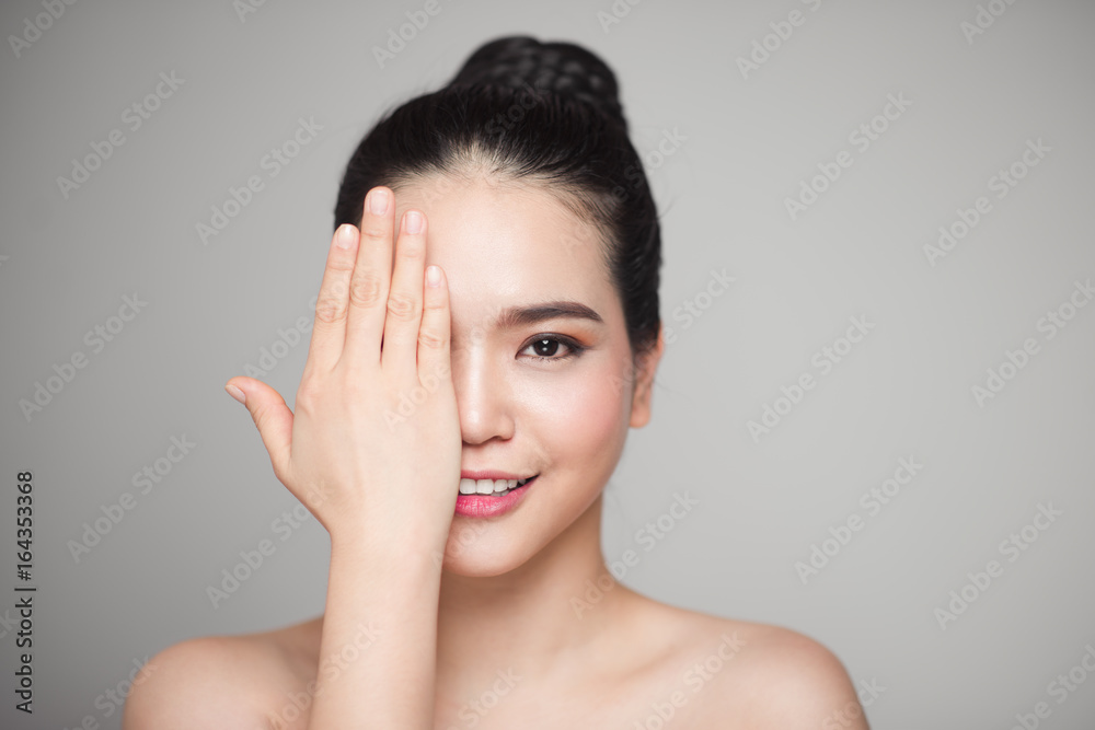 Happy smiling beautiful asian woman touching her face. Happy smiling beautiful asian woman touching her face.
