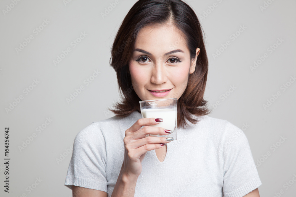 Healthy Asian woman drinking a glass of milk. Healthy Asian woman drinking a glass of milk.