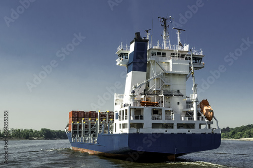 A container feedership leaving port on a sunny day photo