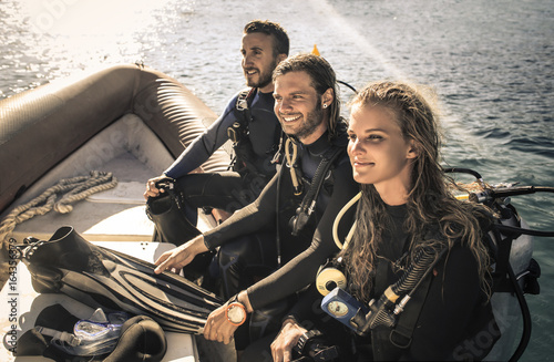Group of scuba divers on a boat ready to dive