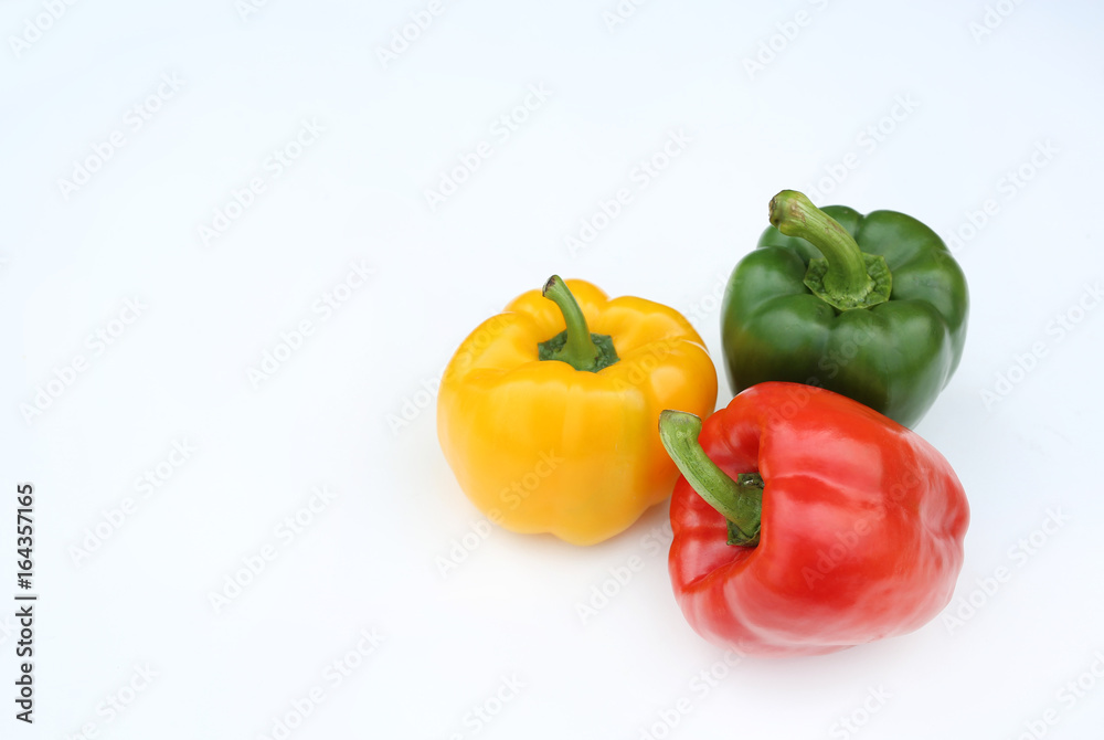 Green, red and yellow bell pepper isolated on white background. Green, red and yellow bell pepper isolated on white background.