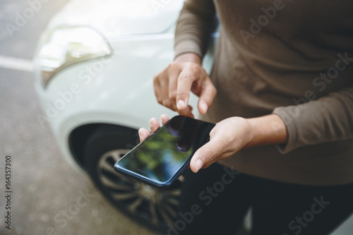 person using phone on road photo