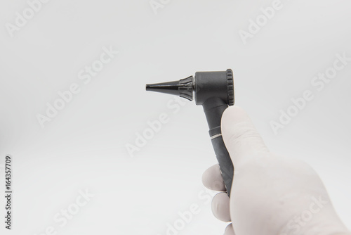Otoscope  in hand doctor on the white background . medical equipment .