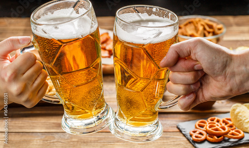 Appetizers and beer on the table for watch the football match.