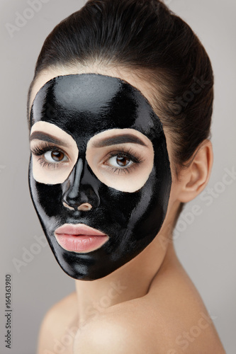 Cosmetology Mask. Beautiful Girl With Black Peel Mask On Skin