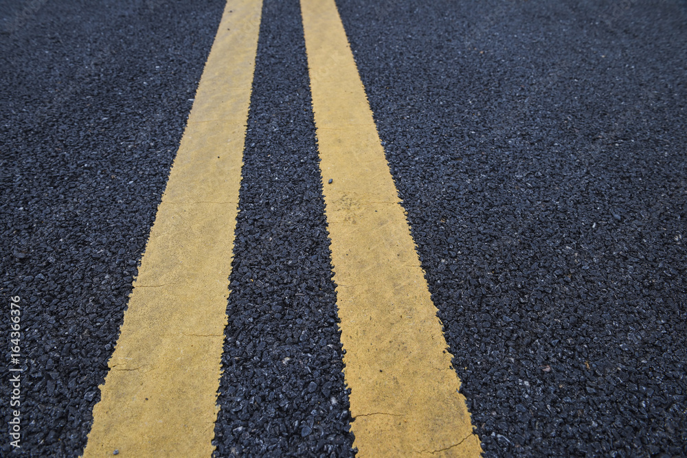 Obraz premium Closeup asphalt road with marking lines for giving directions, traffic lines concept