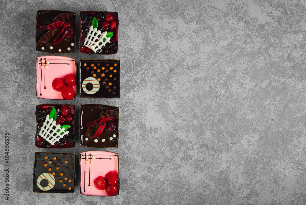 Fototapeta premium Different pastries tasty assortment. Dessert tray assorted top view background. Cakes, bright, colorful pastry sweets with fresh berries. French Bakery pattern. Flat lay. Blank space.