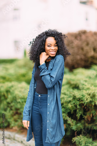 Young african american girl in jeans posing 