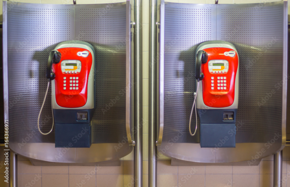 Red public telephone two booth on subway station. Red public telephone two booth on subway station.