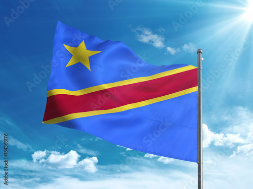 Democratic Republic of the Congo flag waving in the blue sky
