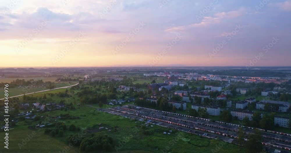 Beautiful Aerial Shot of Misty Sunset in small town. Stormy colorful clouds fog above the city. Beautiful Aerial Shot of Misty Sunset in small town. Stormy colorful clouds fog above the city.