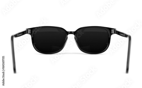 Back view of sunglasses isolated on white background. In black plastic frame. Close up.