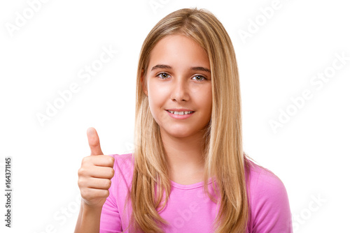 Portrait of lovely teenage girl with thumbs up.Isolated