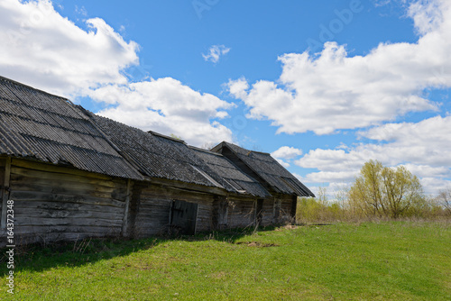 Old dilapidated wooden house on a bright sunny day