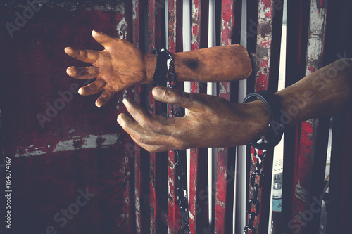 Valokuvatapetti Human hand of ghost prisoner on steel lattice close up for Halloween background