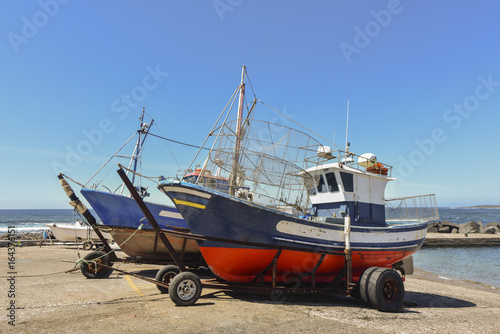 Fishing boats on land with fish trap for lobster and crab fishing in front of the sea, Lanzarote, Spain, Europe