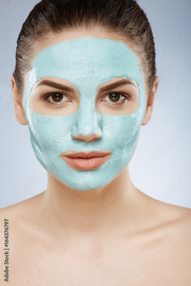 Pretty girl doing cosmetic face mask Pretty girl doing cosmetic face mask