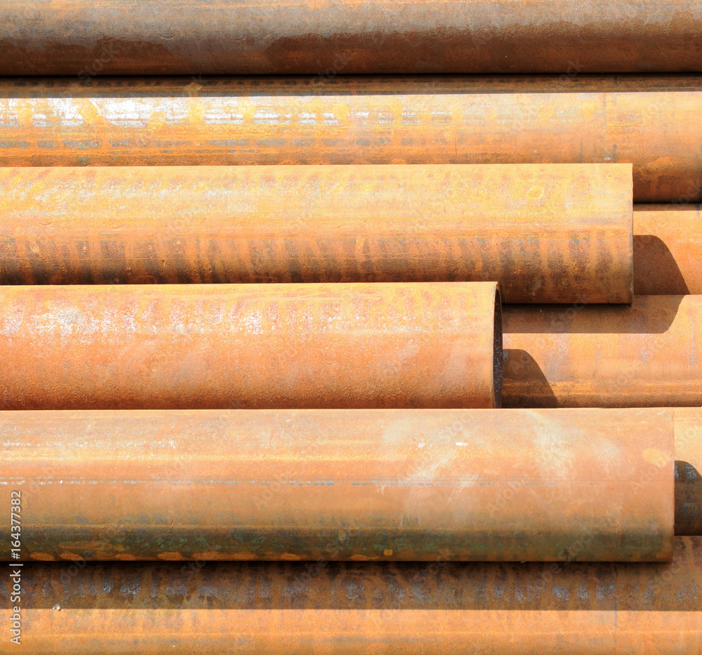 Background consisting of steel pipes covered with a layer of red rust Background consisting of steel pipes covered with a layer of red rust