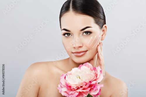 Gorgeous girl wearing white rowel and holding flower