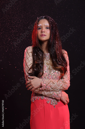 Woman with Gllitter Snowflake in dark background photo