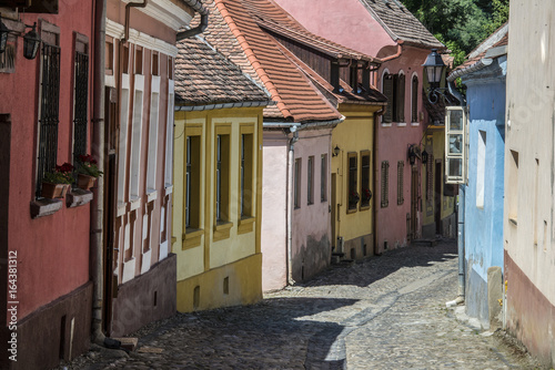 ROMANIA, SIGHISOARA, narrow cobblestone streets with traditional housesare typical for the old city center of Sighisoara, a UNESCO world heritage site