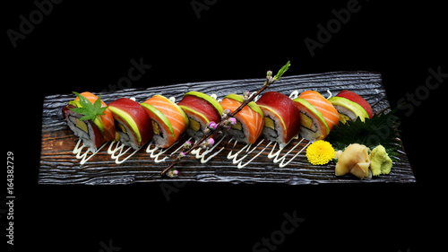 Tuna sushi maki roll and Salmon sushi maki roll. Japanese sushi fish roll on black isolated background. Japanese tradition fusion food style.