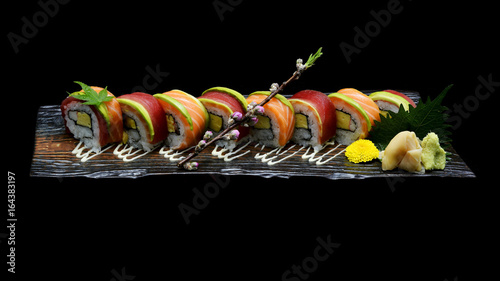 Tuna sushi maki roll and Salmon sushi maki roll. Japanese sushi fish roll on black isolated background. Japanese tradition fusion food style.