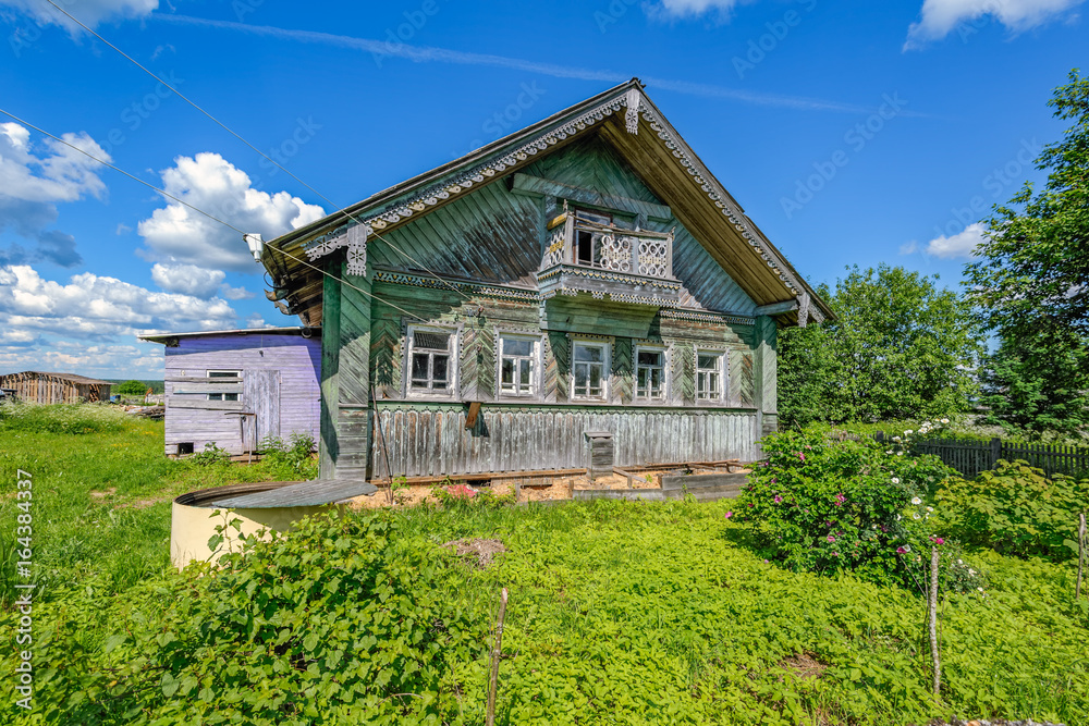 Abandoned old house in a Russian village with ornaments on the facade. Abandoned old house in a Russian village with ornaments on the facade.