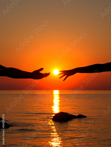 Hands in love in the setting sun