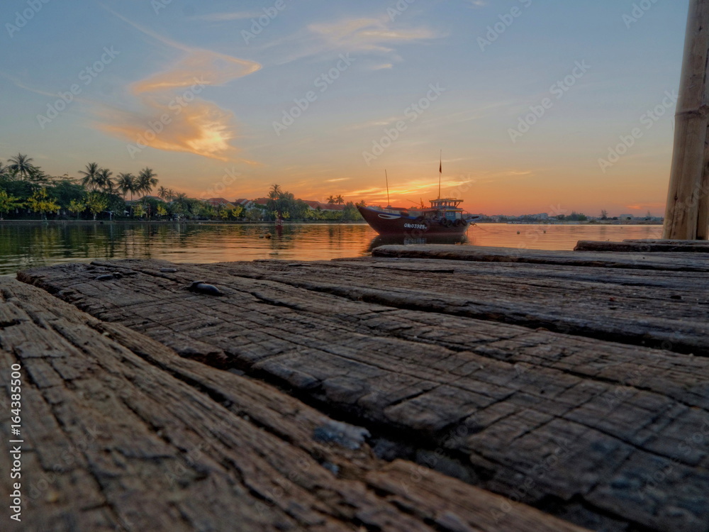 Wood, boat and sunrise