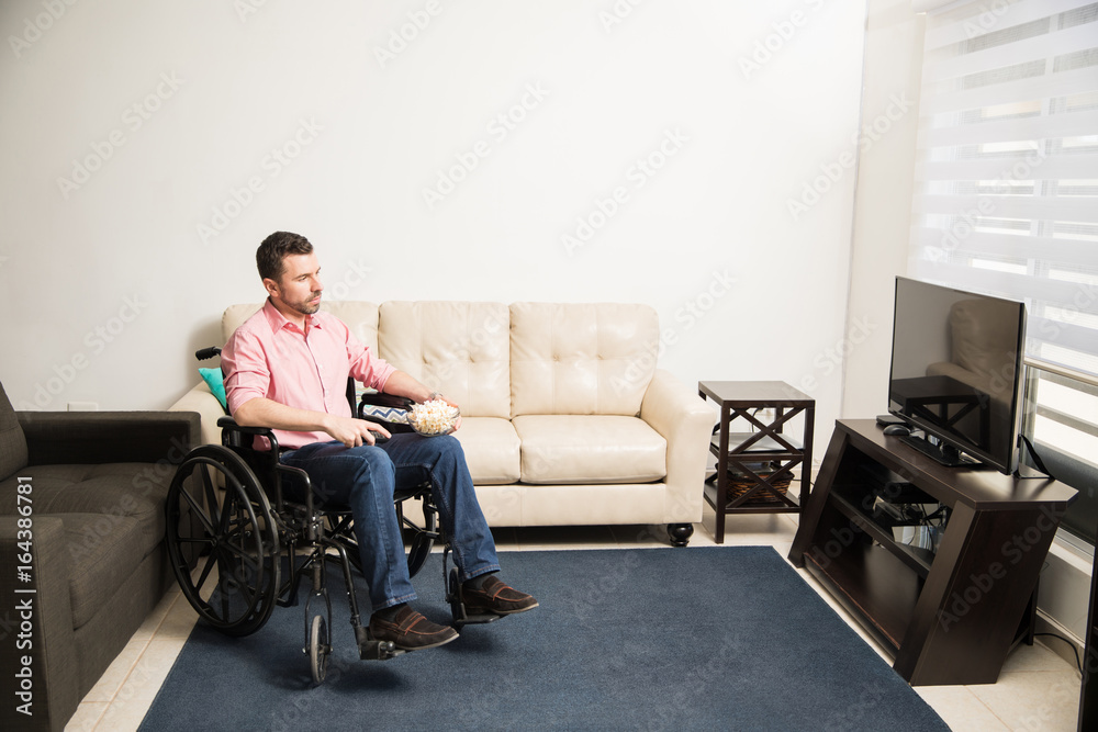 Depressed man on a wheelchair at home
