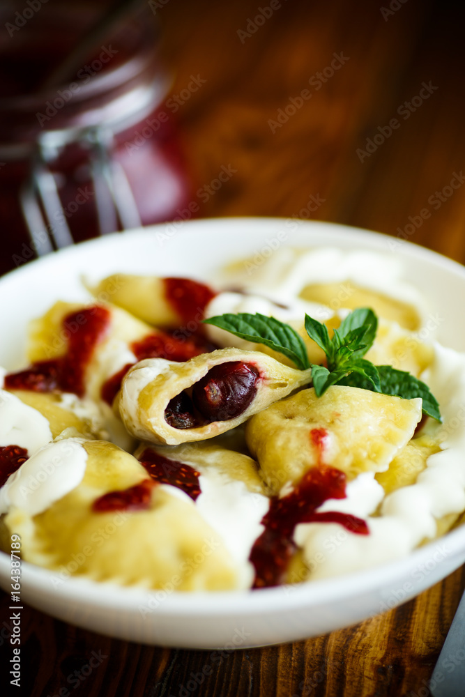 Homemade sweet dumplings with berries and sour cream Homemade sweet dumplings with berries and sour cream