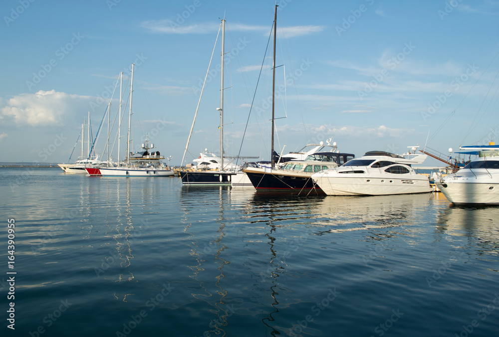 Row of luxury yachts mooring in a harbour.