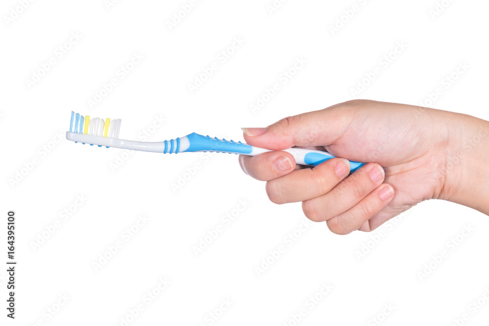 Toothbrush in woman's hand isolated on white Toothbrush in woman's hand isolated on white