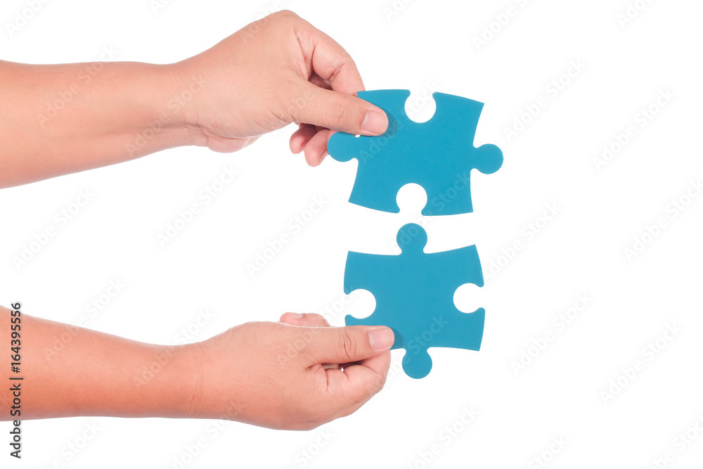 Hand holding jigsaw isolated on white background Hand holding jigsaw isolated on white background
