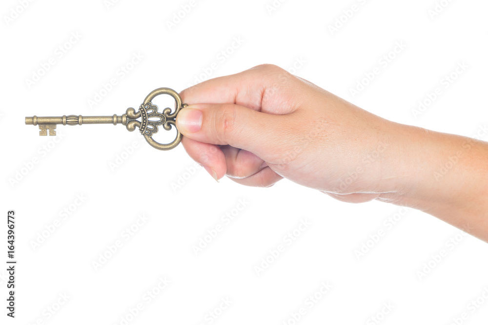 woman's hand holding an antique key isolated on white background woman's hand holding an antique key isolated on white background
