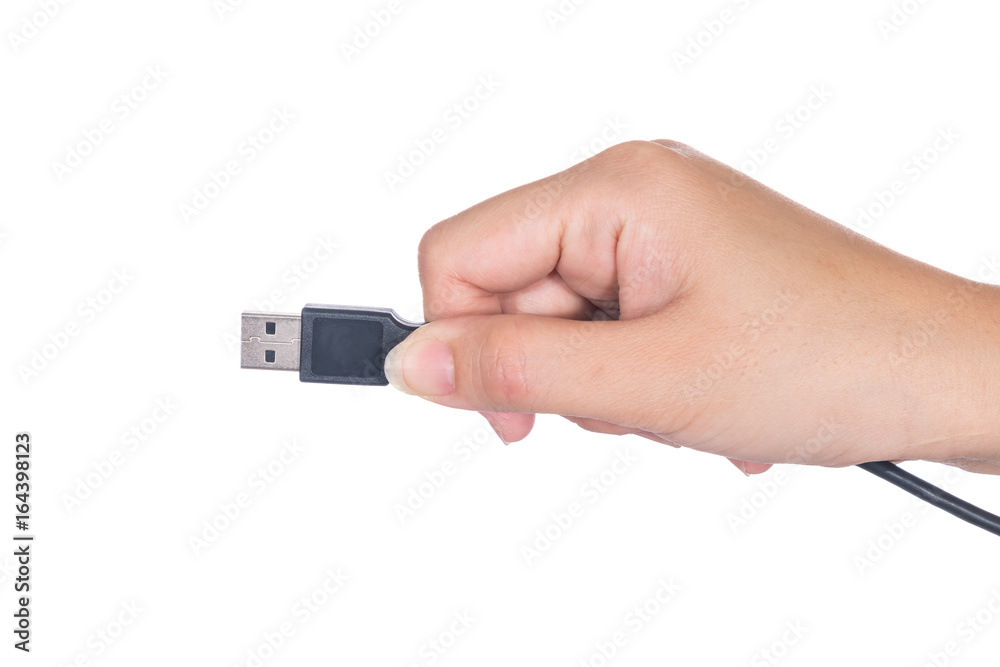 Hand holding USB cable isolated on white background Hand holding USB cable isolated on white background