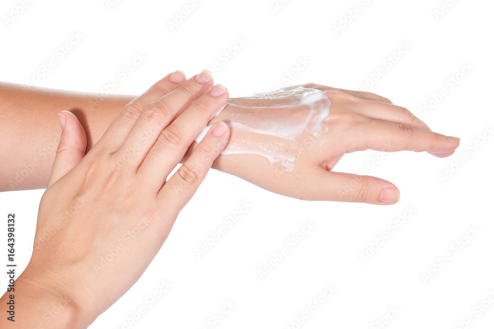 Close up of woman's hands with cream isolated on white background