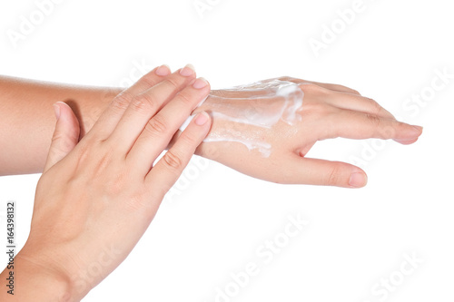 Close up of woman's hands with cream isolated on white background