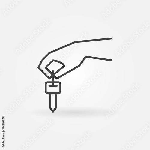 Hand holding car key icon